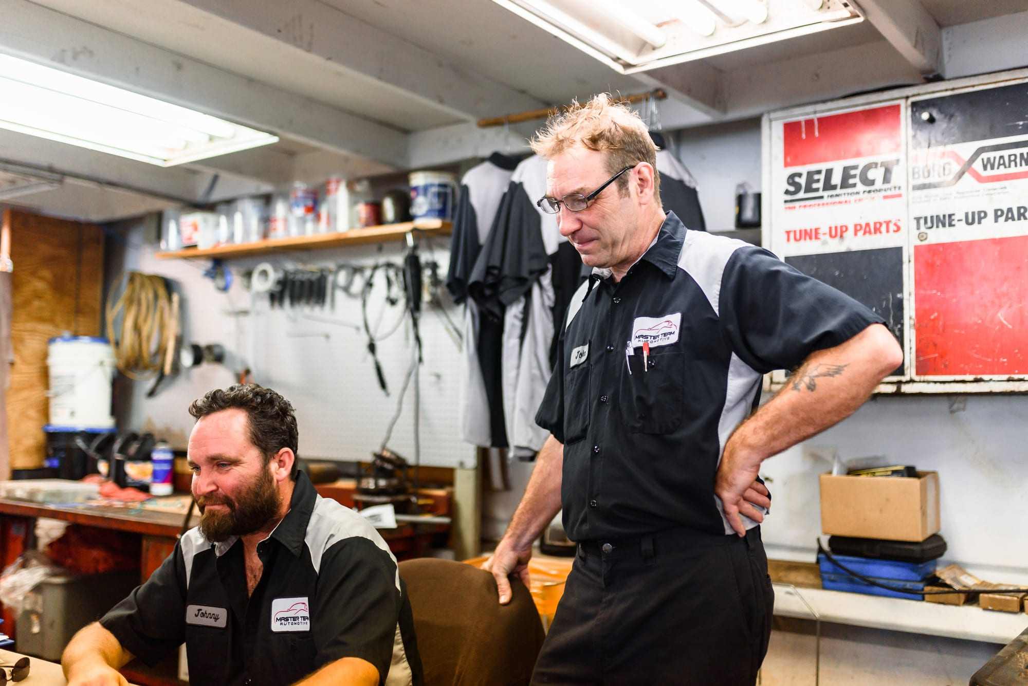 Two Master Team Automotive technicians talking in the shop