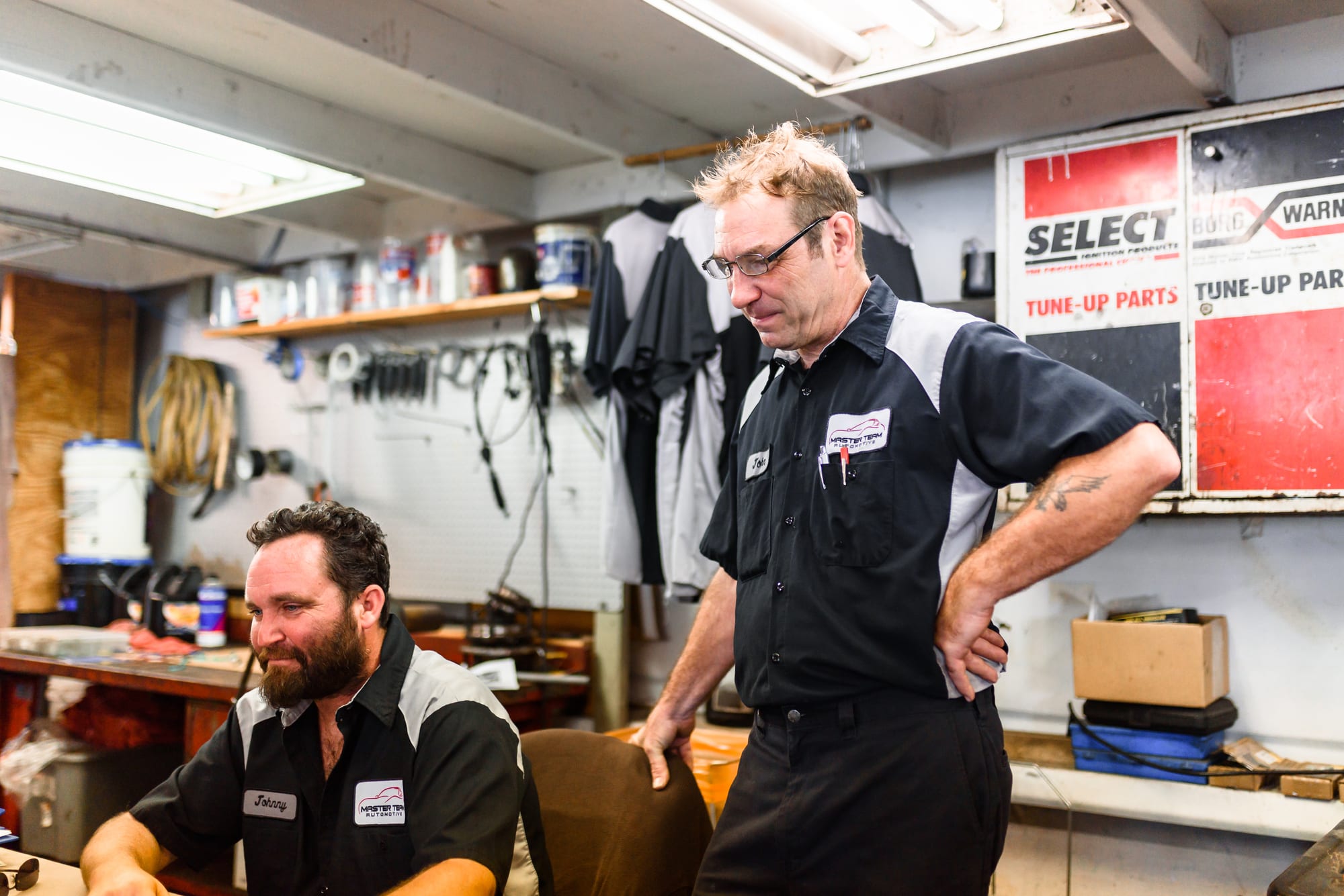 Two Master Team Automotive technicians talking in the shop
